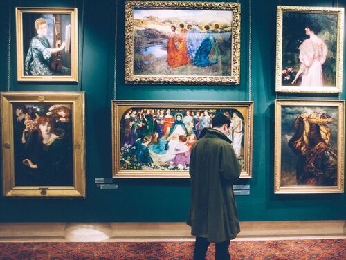 Man looking at paintings